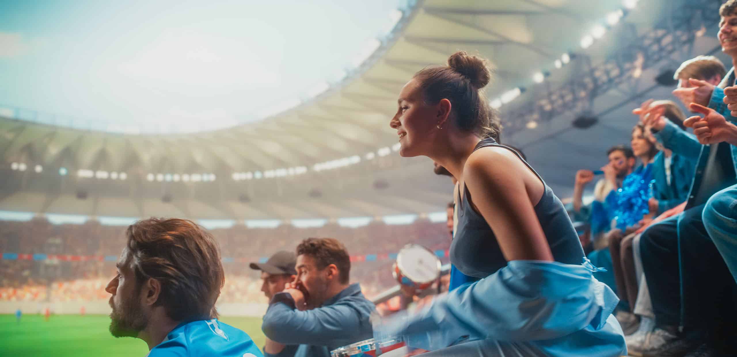 Crowd of soccer fans watching a game in a stadium
