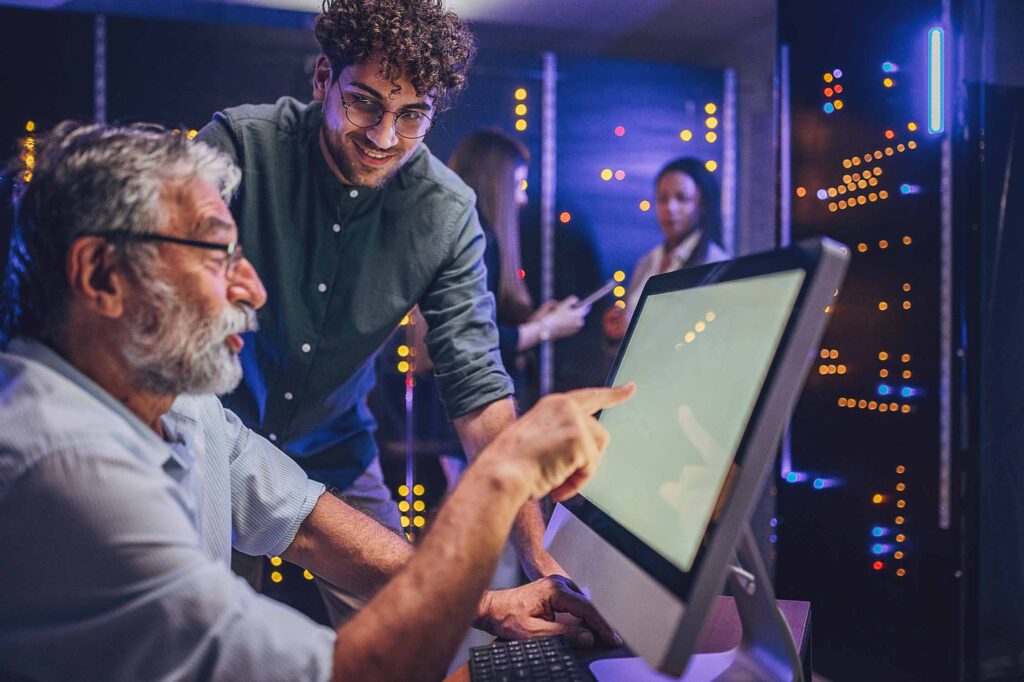 Two Consultants talking in front of servers