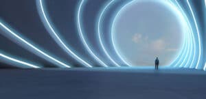 A single person stands in a large, futuristic hall with curved white walls, looking through a circular opening at a bright blue sky. Teaser Telco campaign