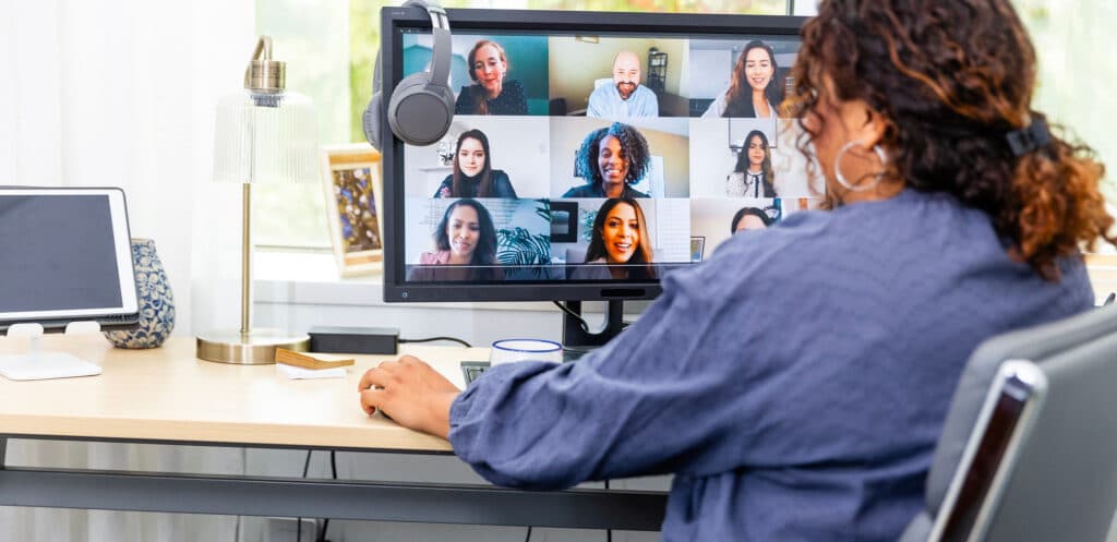 Professional participating in a remote TOGAF® Enterprise Architecture course via video conference, with multiple participants visible on screen.