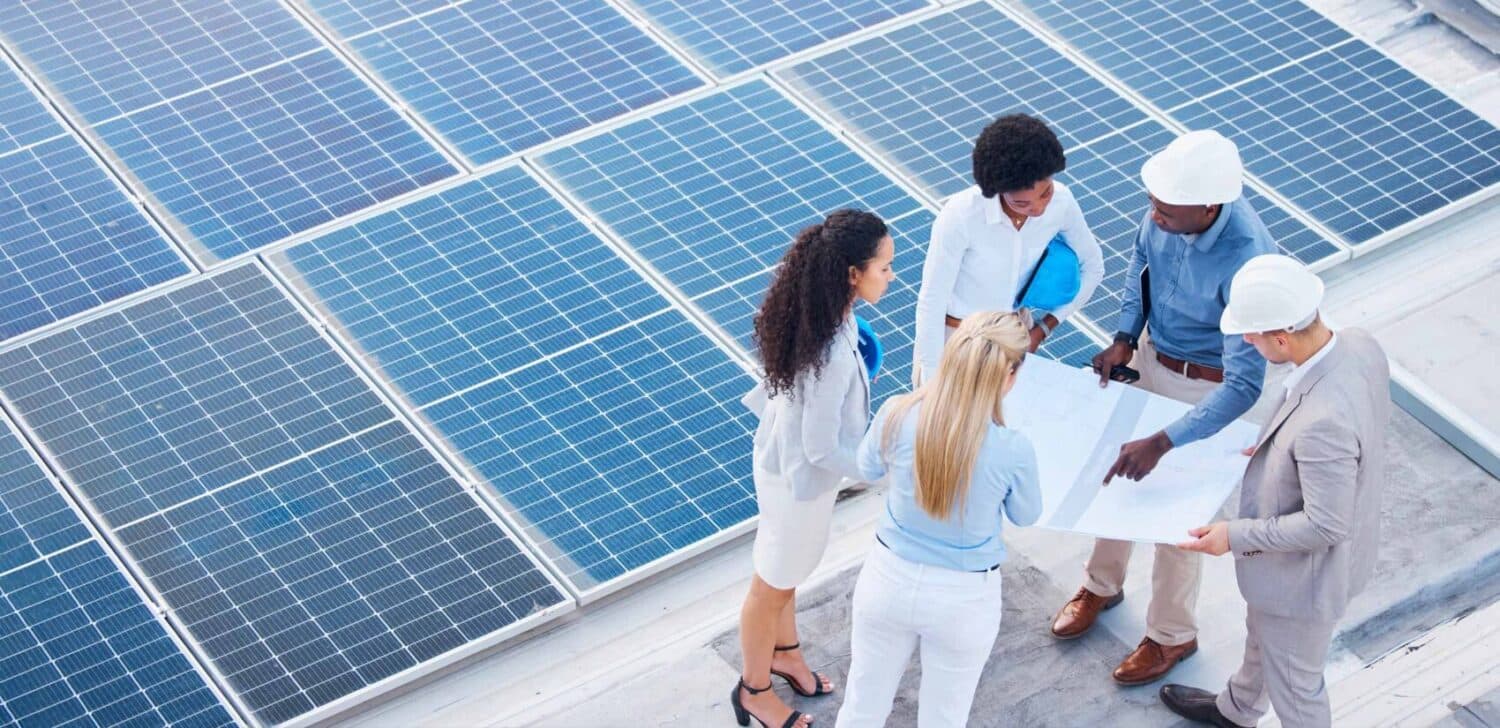 Group pf Workers with solar panels in the background