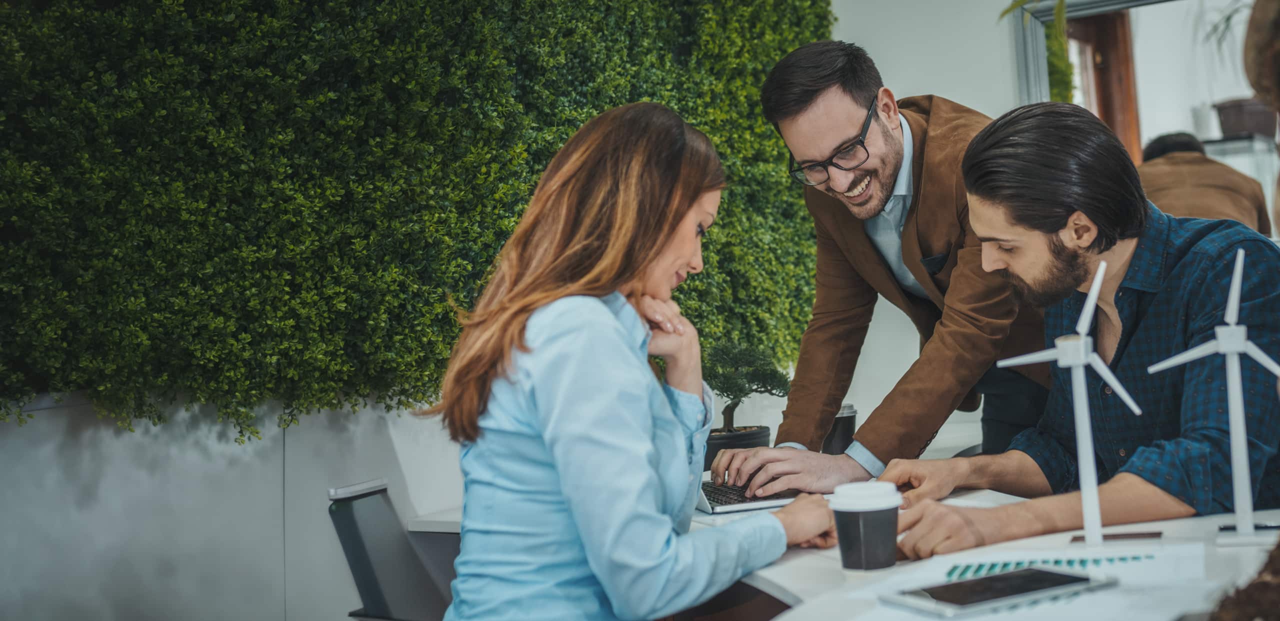 Three business people at a desk discussing energy topics